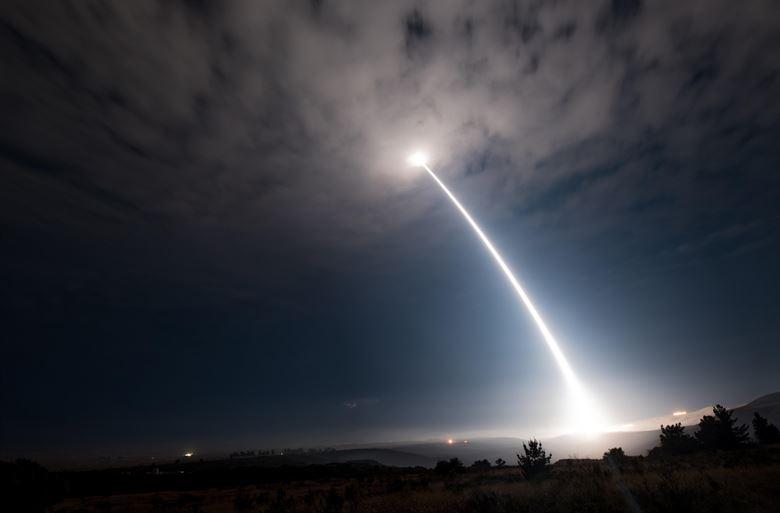A missile being launched into the night sky.