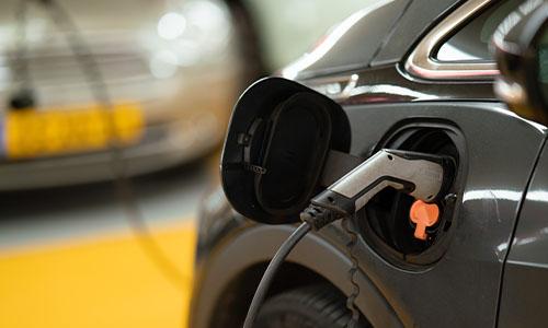 An electric car plugged into a charger.