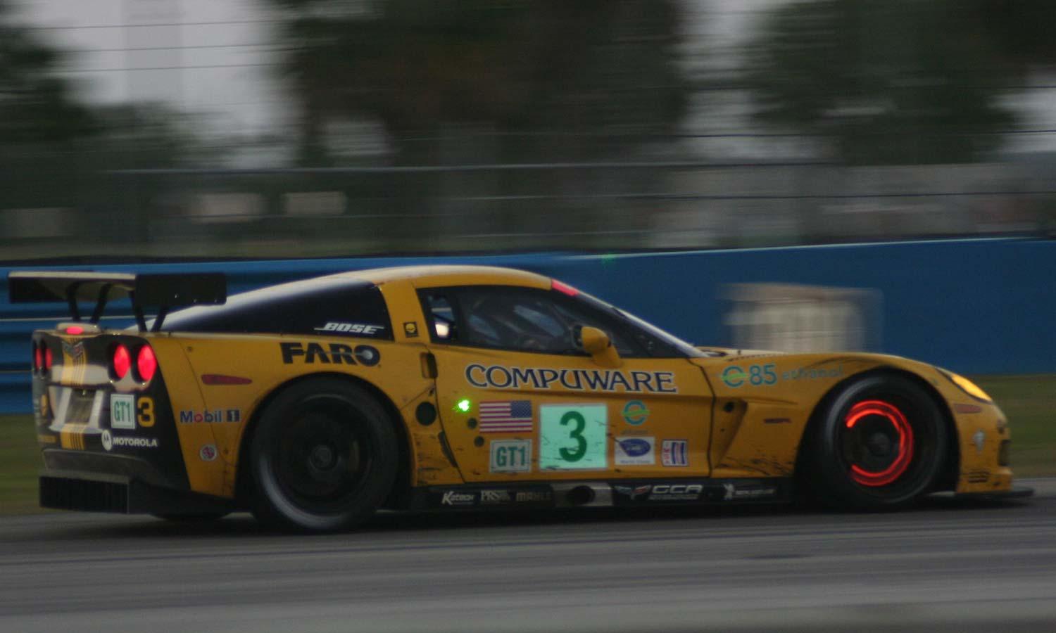 a yellow corvette with glowing brakes at the 2008 12 Hours of Sebring event
