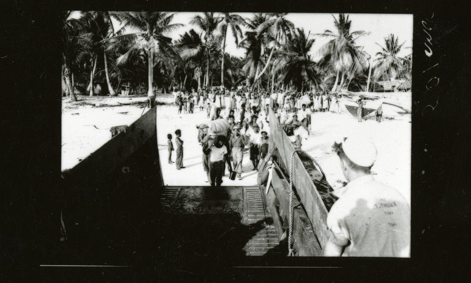 Residents of Bikini Atoll in the Marshall Islands board landing craft