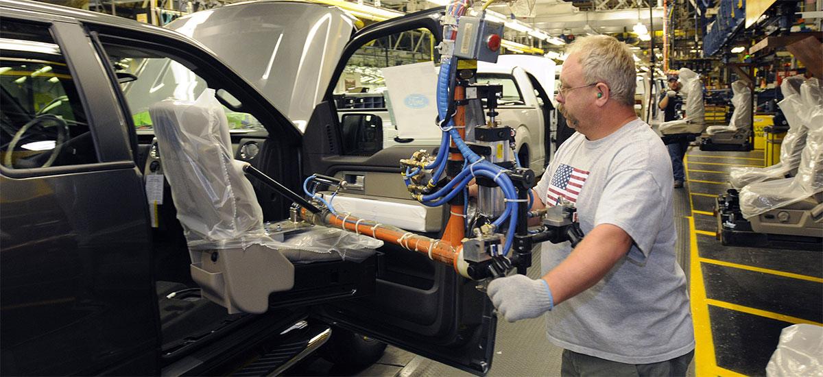 Auto worker installing car seat