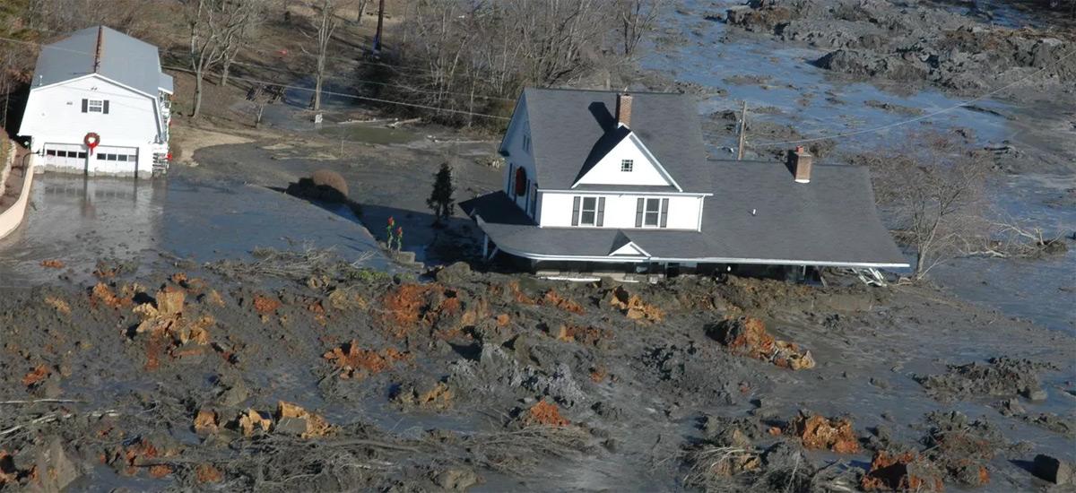 A house partly submerged in a coal ash spill