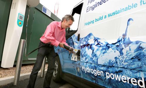Man recharging hydrogen fuel cell vehicle