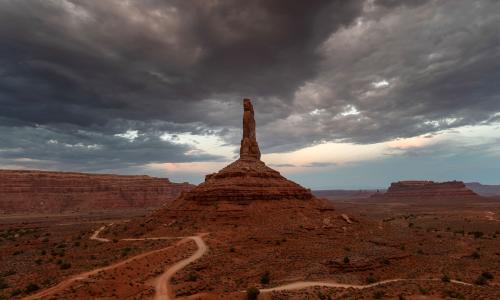 Dramatic view of sandstone tower in Valley of the Gods in Utah under stormy skies