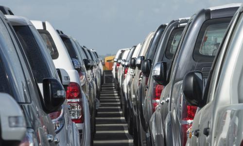 Back view of a fleet of vehicles parked in a car sales lot