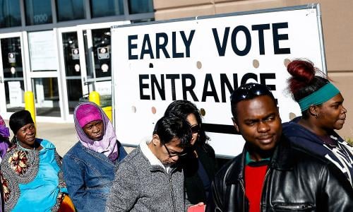 Voters stand outside an early voting poll entrance