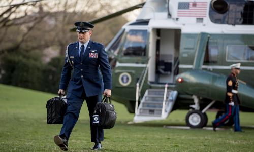 U.S. military aide carries "president's emergency satchel," across White House South Lawn