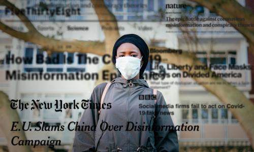 Woman in protective mask with newspaper headlines