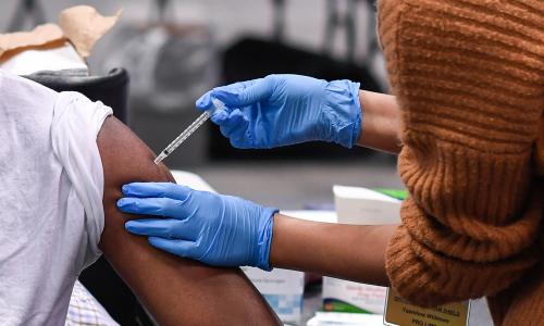 Closeup of COVID-19 vaccine being injected into a person's arm