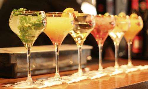 A row of cocktails on a bar