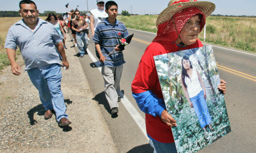 Farmworkers protest carrying photo of Maria Isabel Vasquez Jimenez