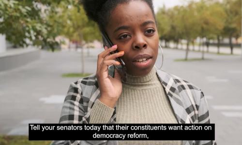 A person uses their cell phone to call their representatives.