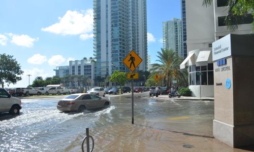 Car driving on flooded street in downtown Miami