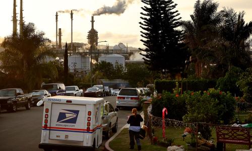 a refinery can be seen from the residential neighborhood abutting it